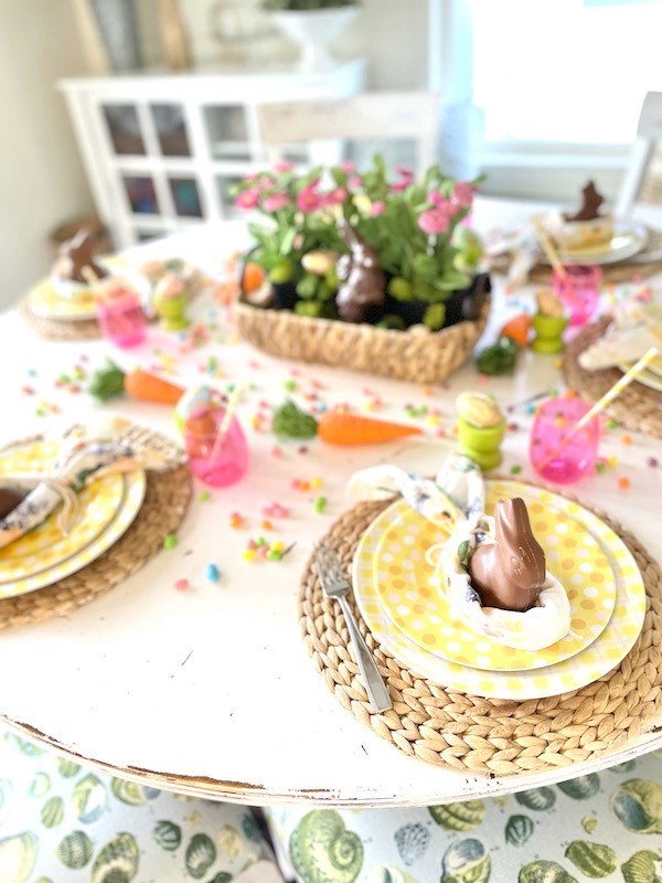 Pink, yellow, orange and white melamine plates for Easter kids table
