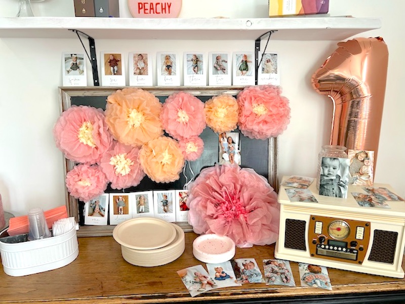 peach themed birthday party with peach colored paper flowers
