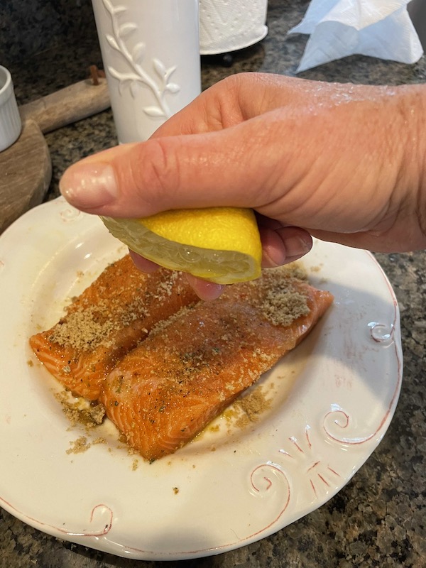 lemon squeezed over salmon