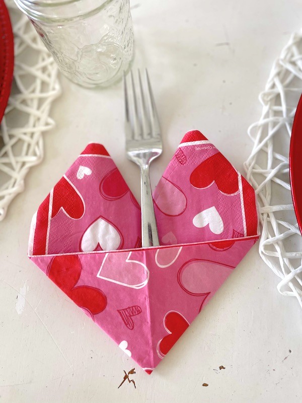 Valentine paper napkins folded into a heart shape