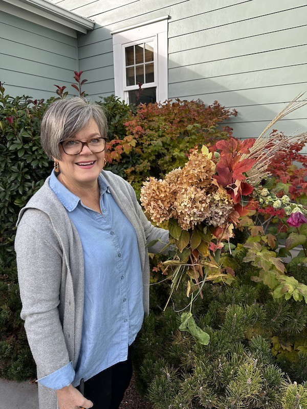 Harvest Elegance: Crafting Thanksgiving Tablescape adding leaves and dried flowers from the garden
