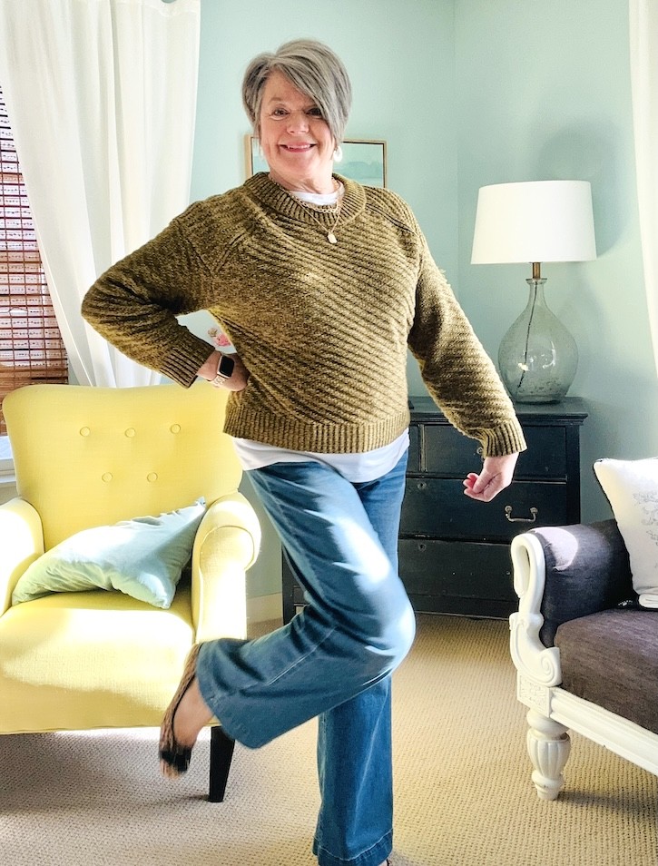 winter outfit for women over 50 with pullover sweater and wide leg jeans