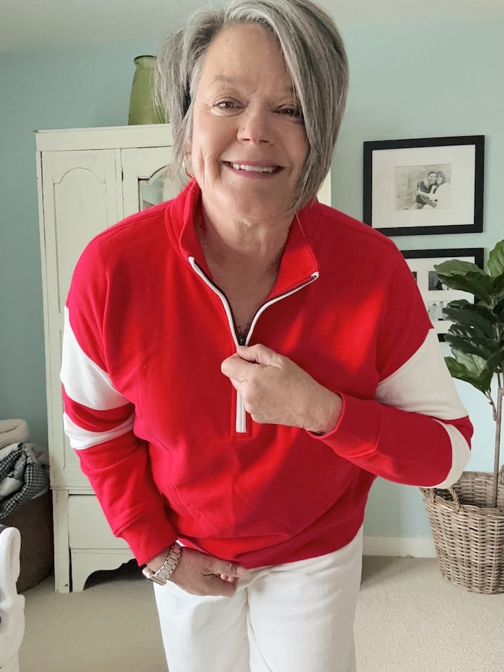 red and white sweatshirt outfit for women over 50 with white cropped pants and sneakers