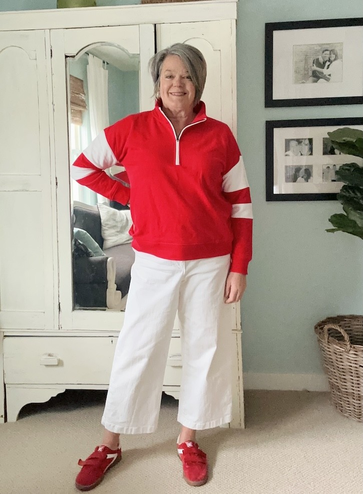 red suede sneakers paired with white cropped pants and sweatshirt outfit