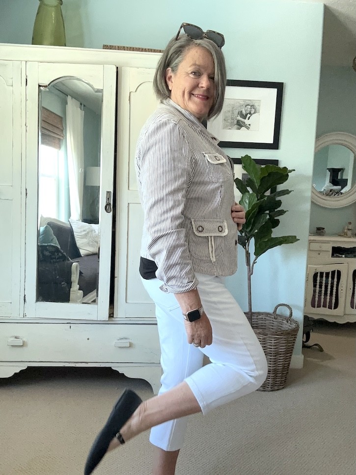 Chic black and white capri pants outfit with striped jacket and crossbody purse for women over 50.