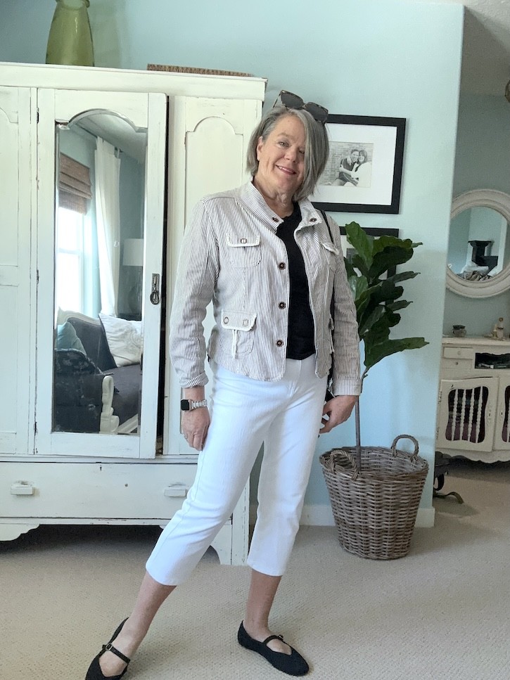 How to wear white capri pants over 50 with a striped jacket, black leather crossbody bag, and black Mary Jane shoes.
