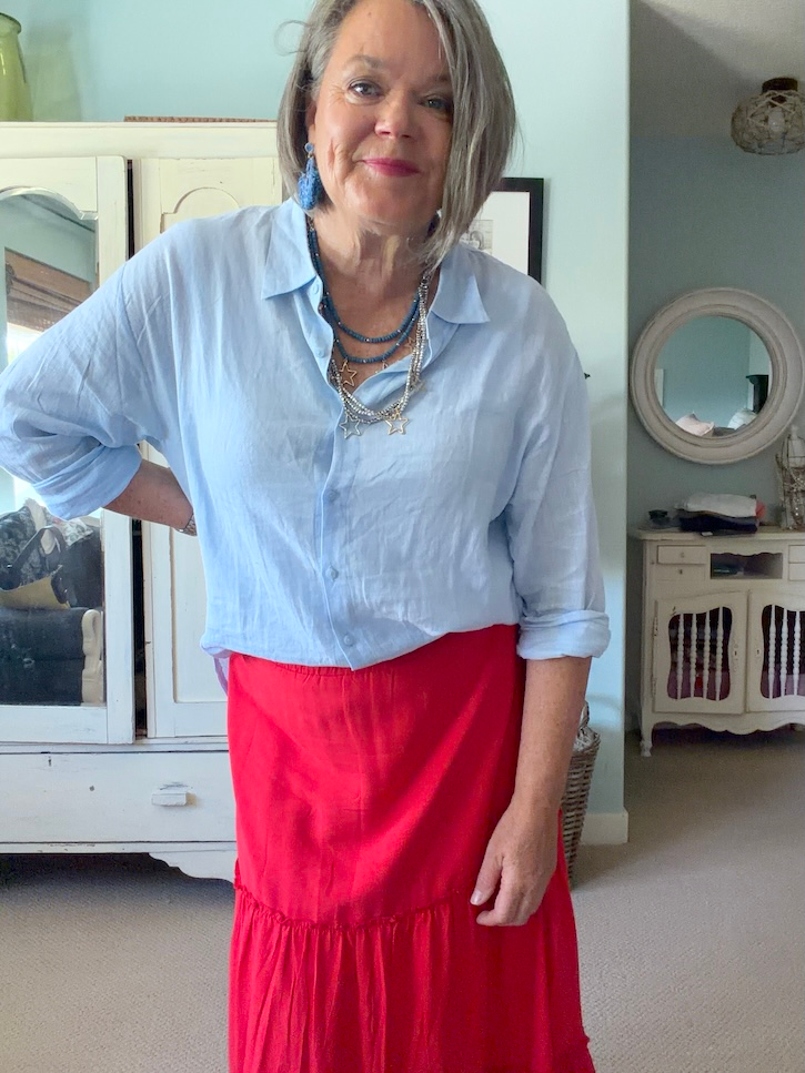 Red tiered skirt with blue linen blouse outfit for women over 50
