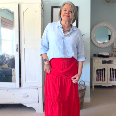 How I styled an affordable red tiered maxi skirt with a linen shirt, sandals and colorful accessories, plus my easy front-tuck trick