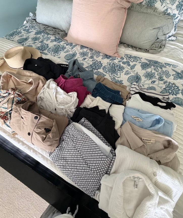 packing for Italy trip 17 days in a carry-on laid out all clothes on bed
