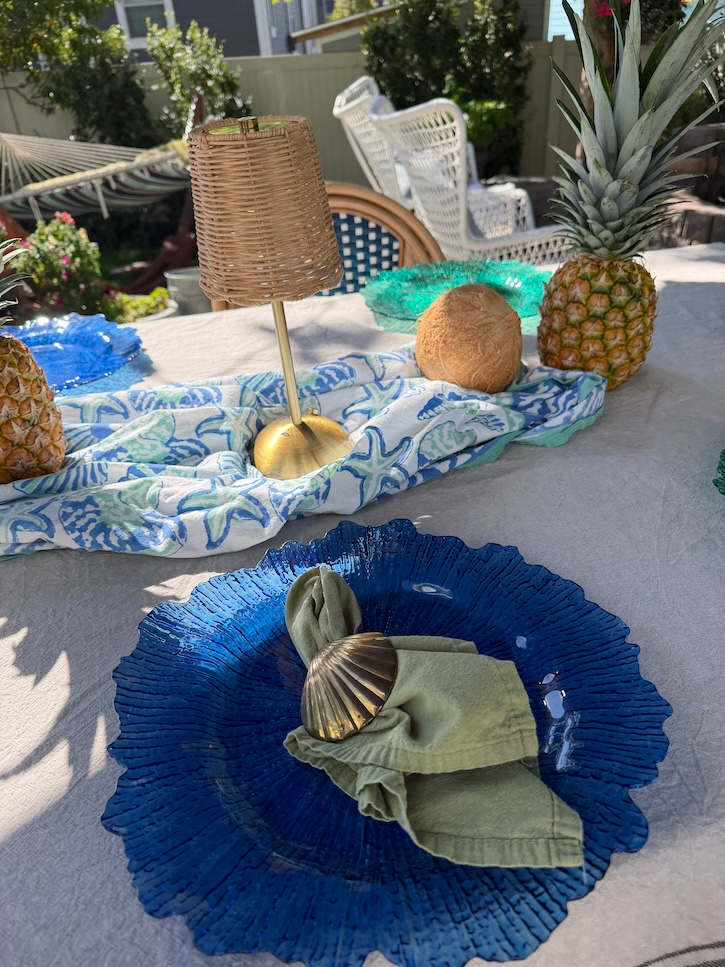 wicker lamp on blue and green Hawaiian tablescape