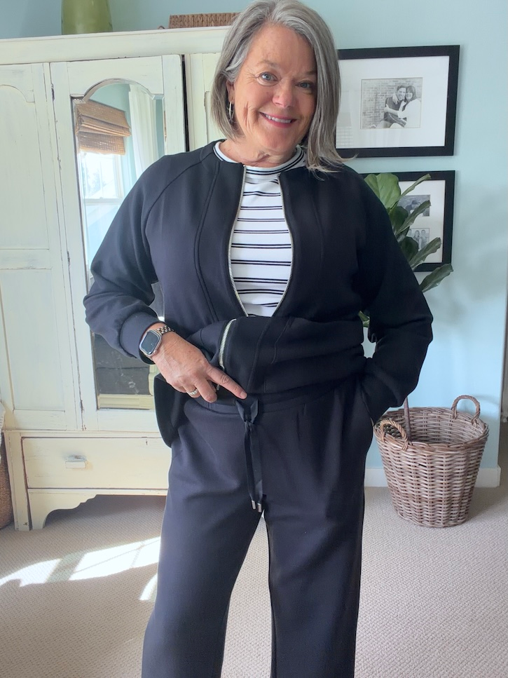 Black straight-leg travel pants with elastic drawstring waist styled for a long flight.