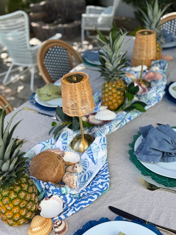 Pineapple centerpiece with sea shells wicker lamps