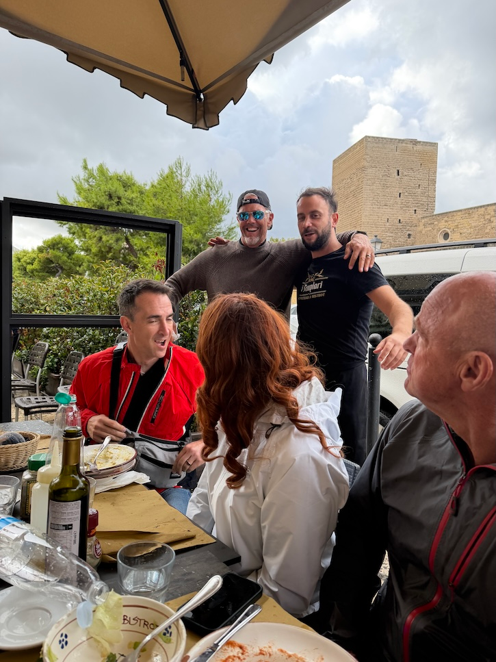 Outdoor restaurant in Bari, Italy, during a rainstorm